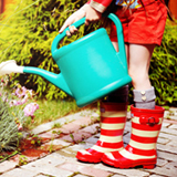 child_watering_plants